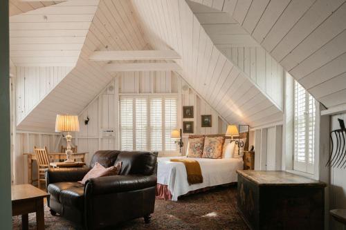 a bedroom with a bed and a chair and a couch at Simpson House Inn in Santa Barbara