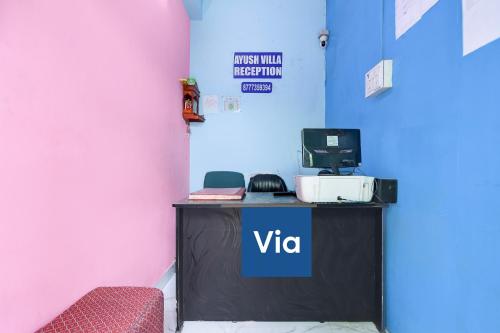 a desk with a tv on top of it in a room at Via Ayush Villa, Hiland Park in Kolkata