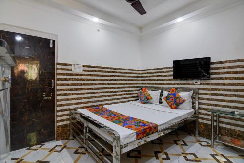 a bed in a room with a wooden wall at Via Ayush Villa, Hiland Park in Kolkata