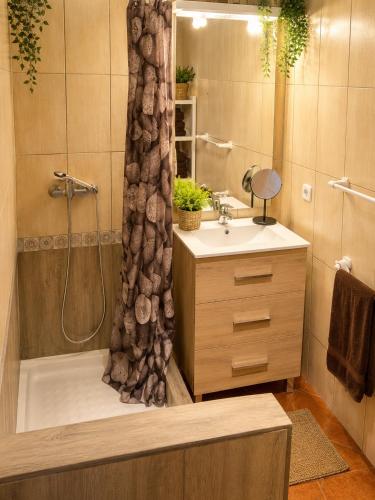a bathroom with a tub and a sink and a shower at Cala Canyelles Villa & Private Studio with Garden in Lloret de Mar
