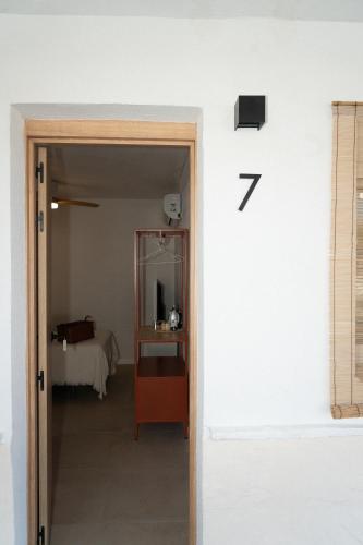 a room with a door with the number seven on the wall at Hostal Playa Pitaya in Torre del Mar