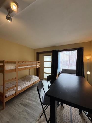 a room with a table and a bunk bed at Douglas in Saint Malo