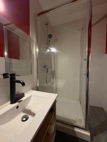 a bathroom with a shower and a sink and a shower at Douglas in Saint Malo