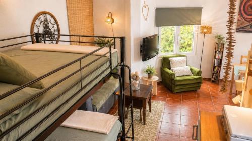 a bedroom with a bunk bed and a living room at Cala Canyelles Villa & Private Studio with Garden in Lloret de Mar