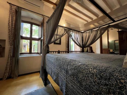 a bedroom with a bed and a window at Gratitude Heritage in Pondicherry