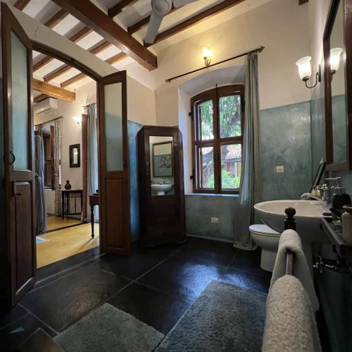 a bathroom with a tub and a toilet and a window at Gratitude Heritage in Pondicherry
