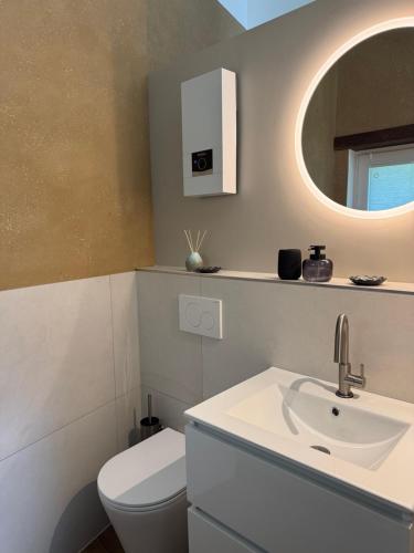 a bathroom with a sink and a toilet and a mirror at Alte Schmiede in Sundern