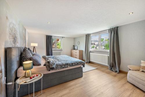a bedroom with a bed and a couch at Ferienwohnung Lea La Milan in Stockach