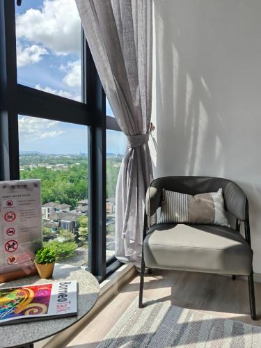a chair in a room with a large window at Milano8 Condominium Opposite Vivacity in Kuching