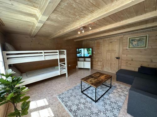 a room with a bunk bed and a table at Chalet Montes in Lauterbrunnen