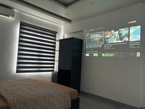 a bedroom with a bed and a wall with a scoreboard at Moon Room in Hai Phong