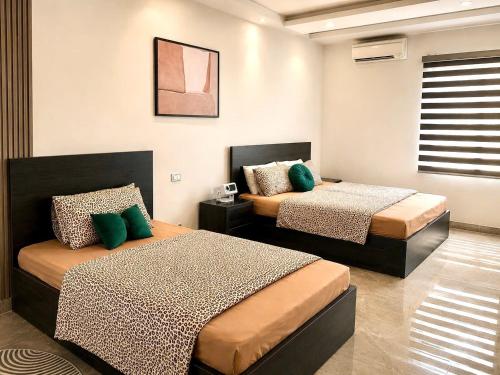 a room with two beds in a room at Moon Room in Hai Phong