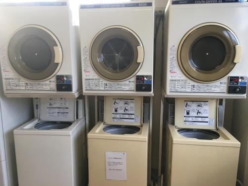a group of washers and dryers in a room at Hotel Tajimi Hills Myroom in Tajimi