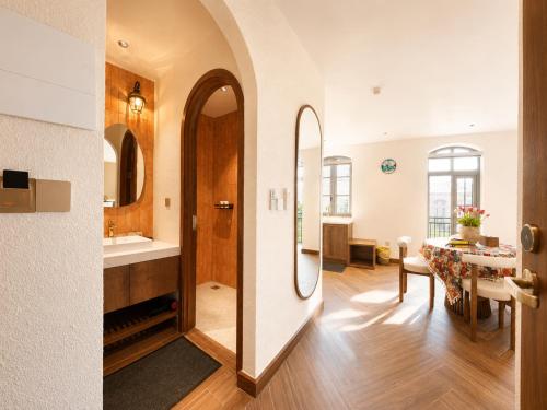 a bathroom with a sink and a dining room at Vistalago Hotel Khem Beach Phu Quoc in Phú Quốc