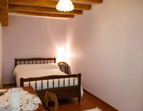 a bedroom with a bed and a table at La Maison des Filles in Sainte-Scolasse-sur-Sarthe