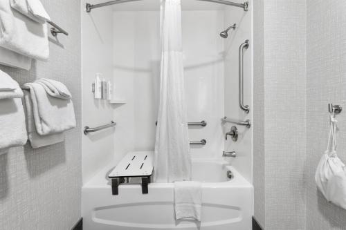 a white bathroom with a tub and a sink at Hampton Inn Salem in Salem