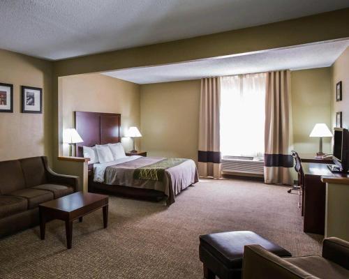 a hotel room with a bed and a couch at Comfort Inn Morris I-80 in Morris