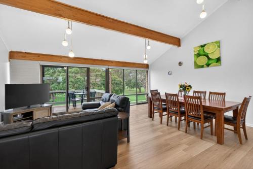 a living room with a couch and a table and chairs at 4 1 Harbour View Terrace BYO Linen in Victor Harbor