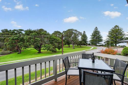 a balcony with a table and chairs and a road at 4 1 Harbour View Terrace BYO Linen in Victor Harbor