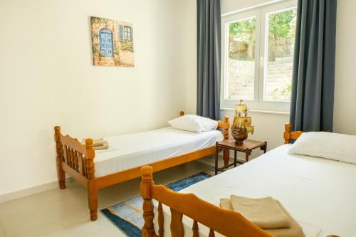 a bedroom with two beds and a window at Apartments Danilo in Herceg-Novi