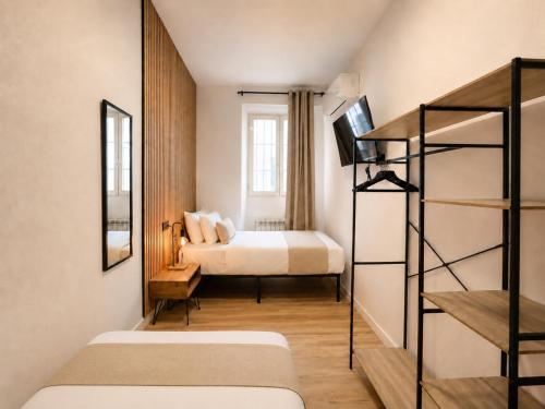 a bedroom with two beds and a bunk bed at Casa Antares Granada in Granada