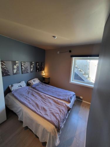 a bedroom with a large bed and a window at Local home apartment in Stavanger in Stavanger