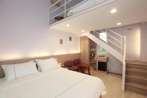 a bedroom with a large bed and a staircase at Gancheng 35 in Jian