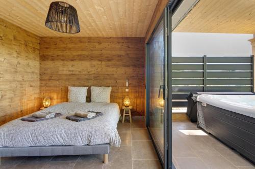 a bedroom with a bed and a bath tub at Lodge Spa Celeste in Sarlat-la-Canéda