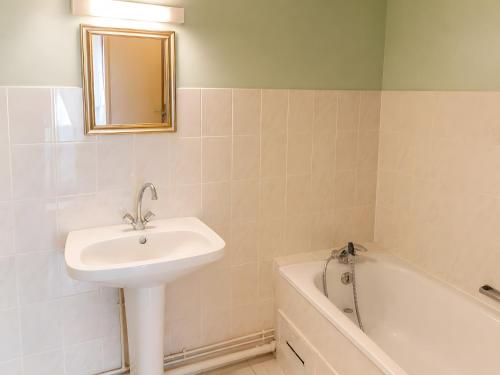 a bathroom with a sink and a bath tub at La Maison des Filles in Sainte-Scolasse-sur-Sarthe