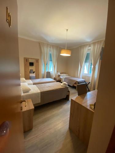 a large bedroom with two beds and a table at ALBERGO LOCANDA DIANA in Genoa