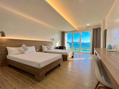a bedroom with two beds and a view of the ocean at Coron Underwater Garden Resort in Coron