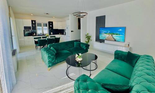 a living room with a green couch and a table at Luxury Villa Domino with Heated Pool in Mostar