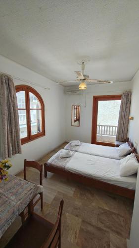 a bedroom with a large bed and a window at Achilleion-Edipsos in Loutra Edipsou
