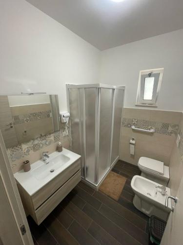 a bathroom with a shower and a sink and a toilet at Affittacamere Sisca Oriolo in Schiavonea