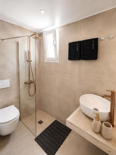 a bathroom with a shower and a toilet and a sink at Sunset studio in Plaka in Plaka Milou