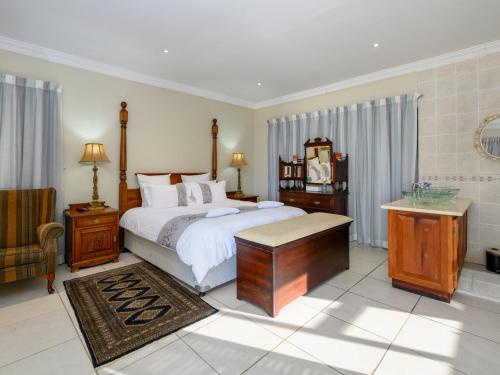 a bedroom with a bed and a table and a chair at Seagull Villa in Margate