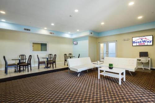 a living room filled with furniture and a tv at Best Way Inn Cleburne in Cleburne