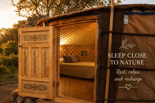 a bed in a tent with a sign on it at La Cera Farm Camping B&B in Santa Teresa Gallura