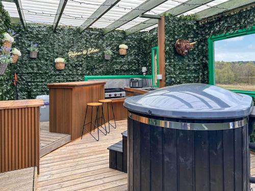 a outdoor kitchen with a barrel in the middle of a patio at Vessel 1 - Ukc9441 in Glasgow