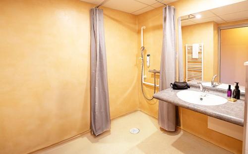 a bathroom with a sink and a shower at Azureva Club Métabief in Métabief