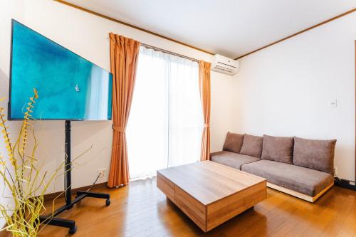 a living room with a couch and a table at Gunkanjima 307 in Nagasaki