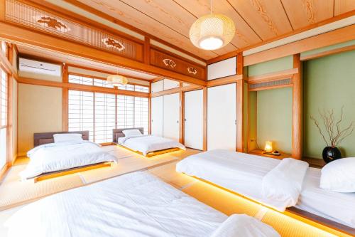 two beds in a room with windows at Gunkanjima 307 in Nagasaki