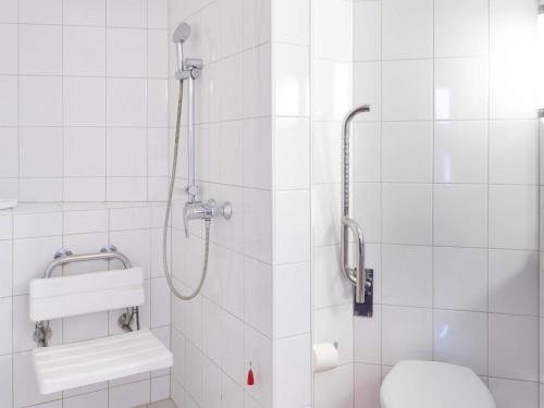 a bathroom with a shower with a toilet and a sink at ibis Basel Bahnhof in Basel