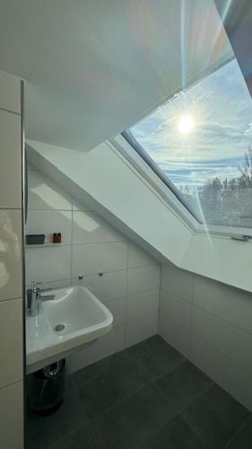 a bathroom with a sink and a window at Hotel Falken in Hechingen