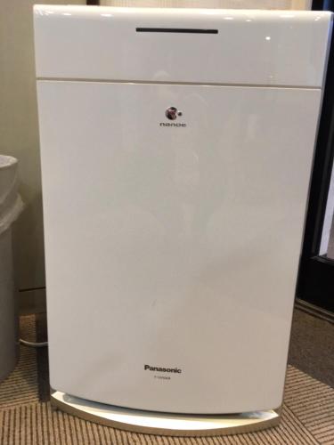 a white refrigerator is sitting on the floor at Hotel Tajimi Hills Riverside in Tajimi