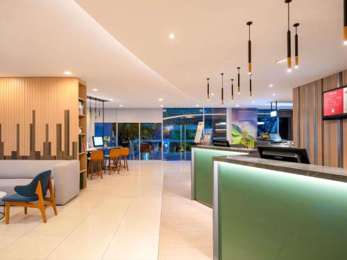 an office lobby with a bar and chairs at ibis Bangkok Sathorn in Bangkok