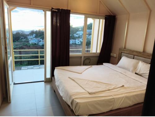 a bedroom with a bed and a large window at Winterfeel Bellmount by Neon Nest in Ooty