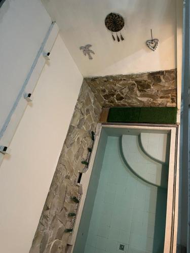 a bathroom with a tile floor and a ceiling at infinite 88 villa in Batu