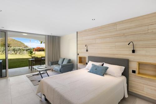 a bedroom with a large bed and a living room at Sun et Sea Dreams in Anse Marcel 