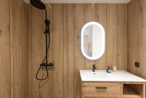 a bathroom with a sink and a mirror at Sun et Sea Dreams in Anse Marcel 